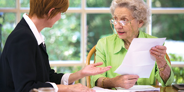 An elderly woman dealing with finances