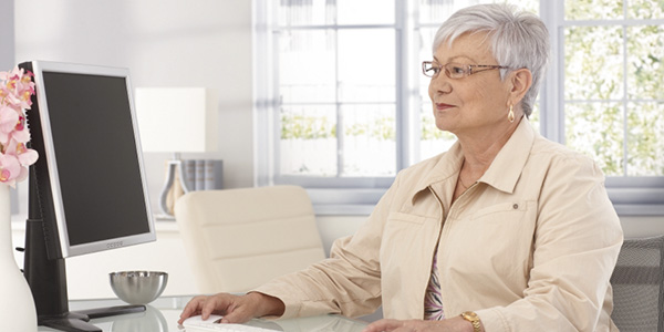 Mature woman using computer at home